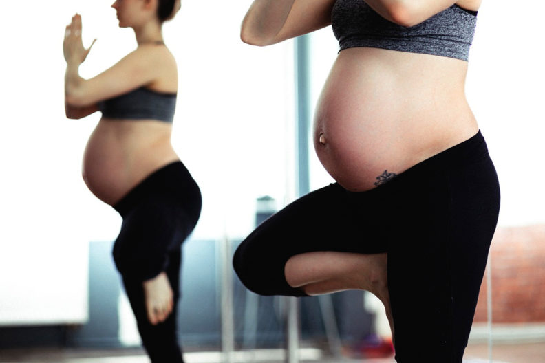 Pregnant woman doing yoga.