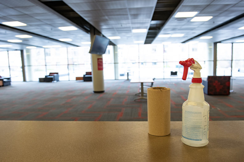 Cleaning supplies on a table in an empty lounge