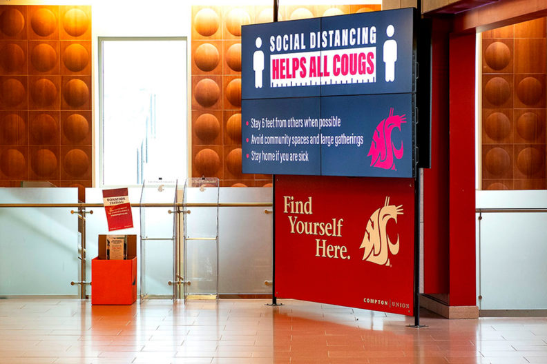 Sign inside the CUB at WSU Pullman promoting social distancing.