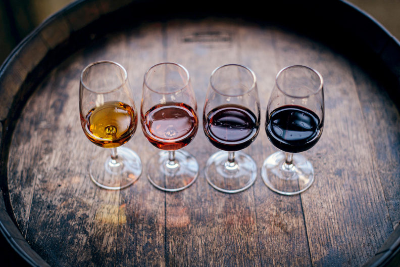 Four glasses of various types of wine.