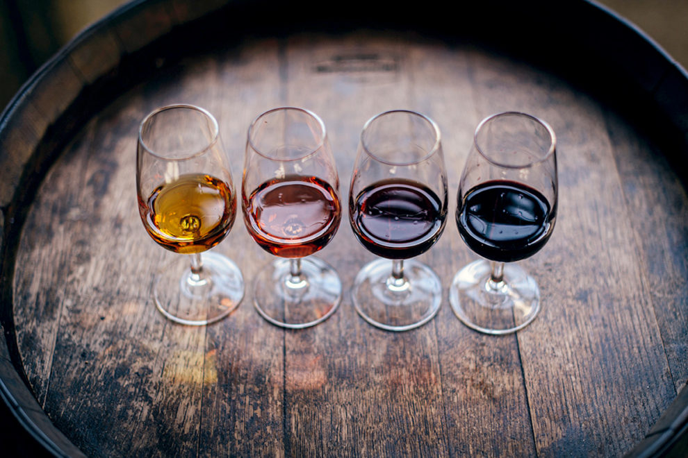 Four glasses of various types of wine.