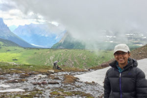 Alisha Shah standing in a snowy field with mountains in the distance