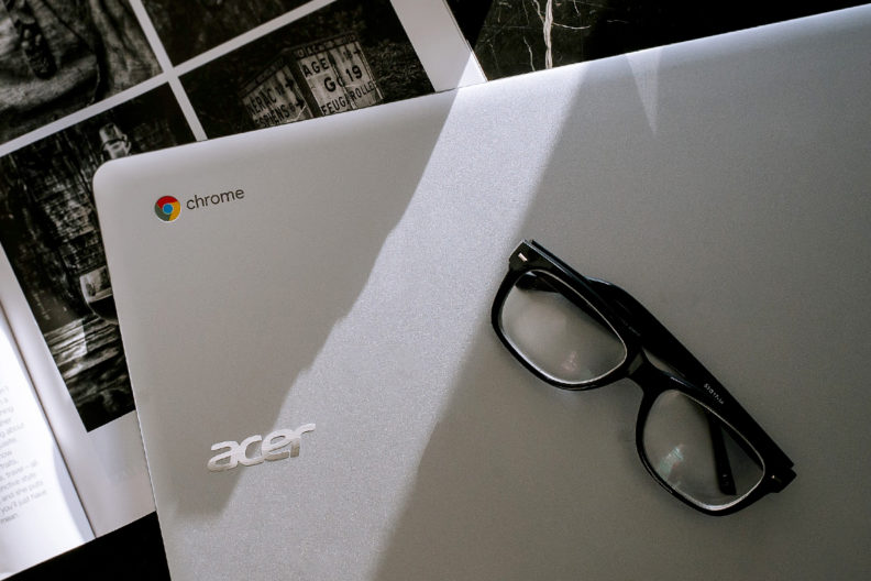 Closeup of a Chromebook and eyeglasses.