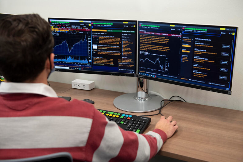 A student looks at financial data on a computer screen