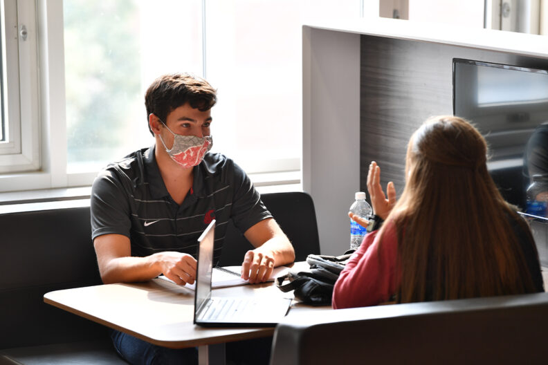 Two students converse about business