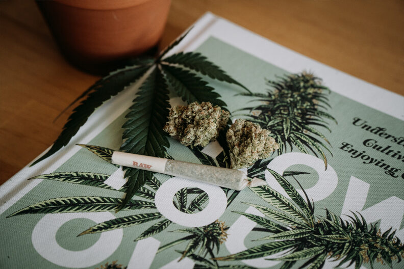A marijuana joint rests on top of a marijuana magazine.