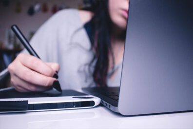 A woman works at a computer