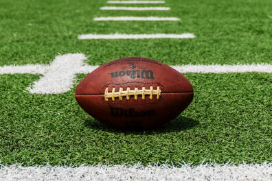 An American football set on an empty field.