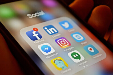 Closeup of a smartphone with social media and other icons.