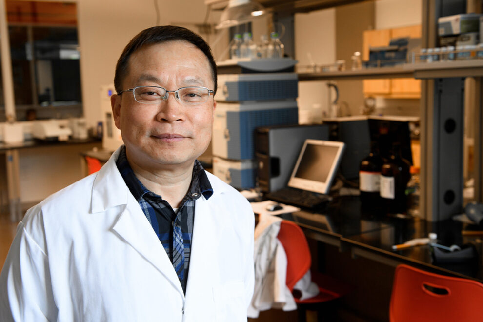 Closeup of Jinwen Zhang in laboratory.