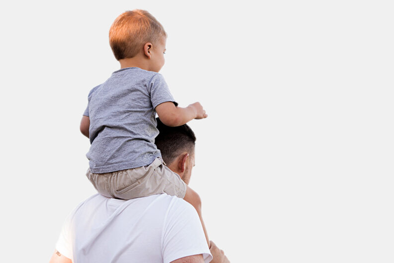 Son sitting on father's shoulders.