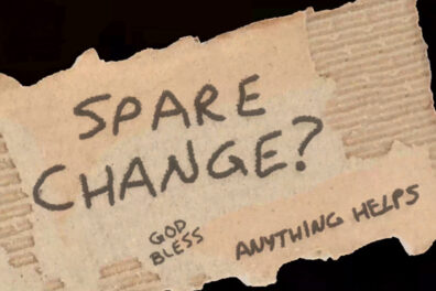 A small sign with spare change? written on it.