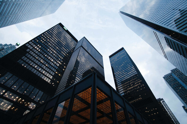 View of New York City skyscrapers from ground level.