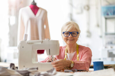 Woman sitting at a sewing machine.