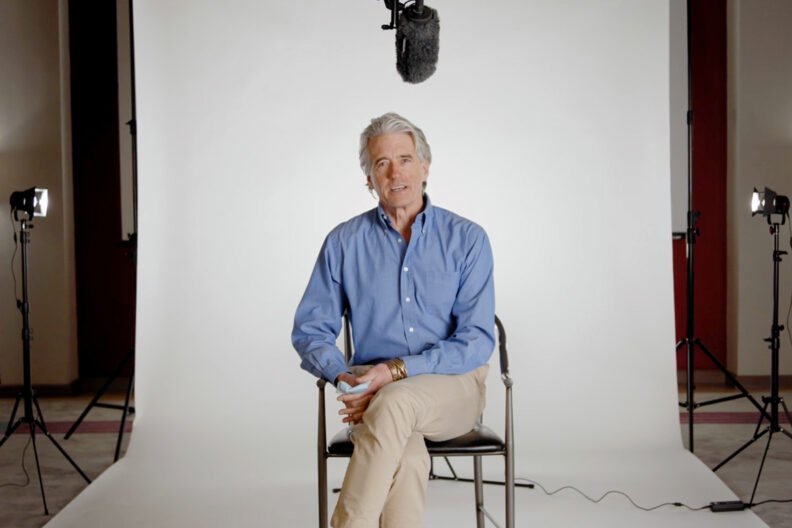 Guy Palmer sitting on set for a video FAQ session.