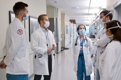 Doctors confer in a hallway