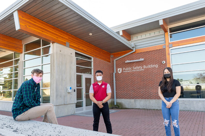 Three masked students in front of the WSU Public Safety Building.