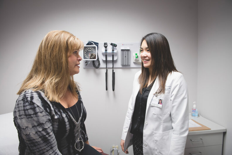 A 4th year medical student works with a patient.