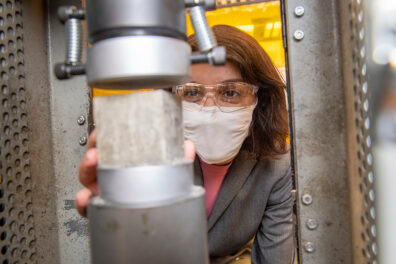 A researcher holds a concrete sample