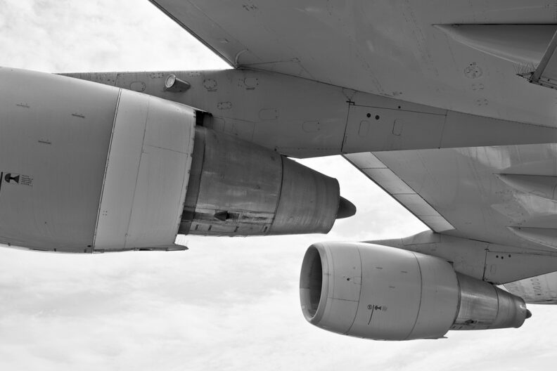 Closeup of aircraft engines in mid-flight.