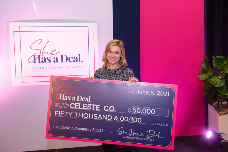 Emma Claire Spring holds a big check she won during a business competition.