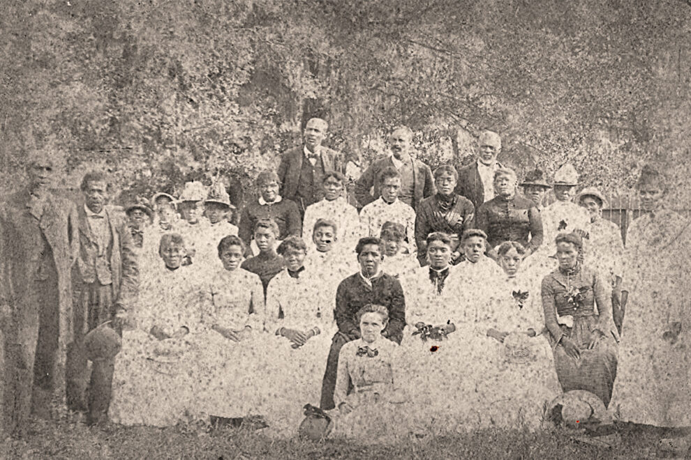 A black and white photo of several men and women at a Juneteenth Celebration in 1880.