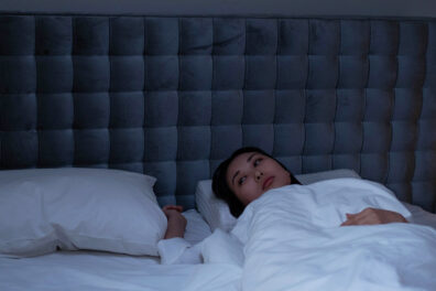 Sleepless woman lying in bed.