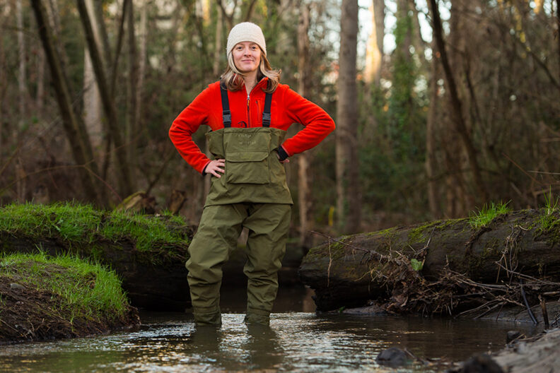 Jen McIntyre wearing waders as she stands in Longfellow Creek.