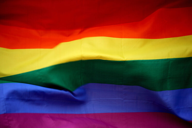 Closeup of a rainbow-colored flag.