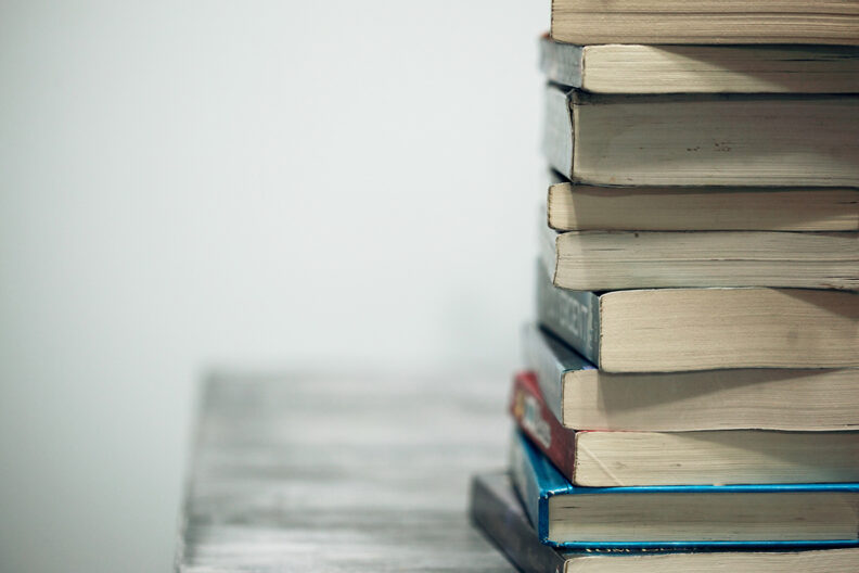 Stack of books on an empty table.