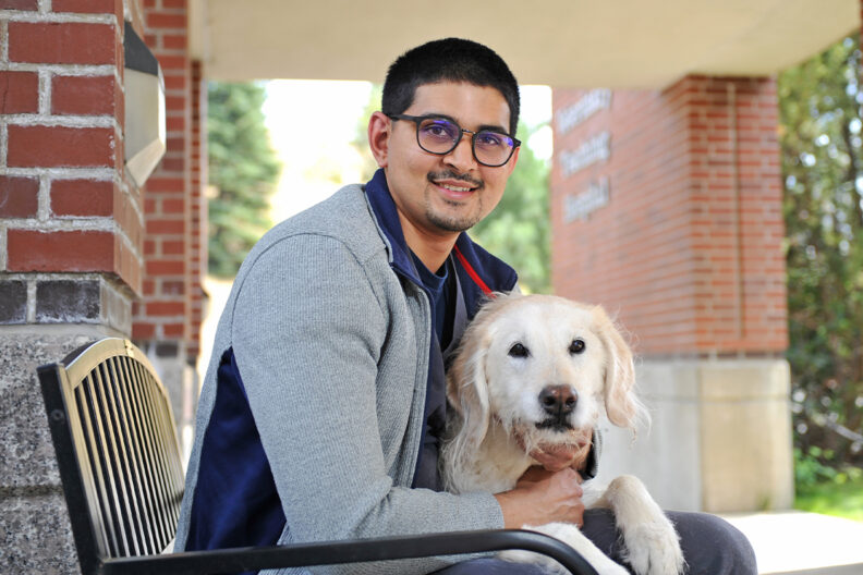 Closeup of Neil Sinha and his dog Molly.