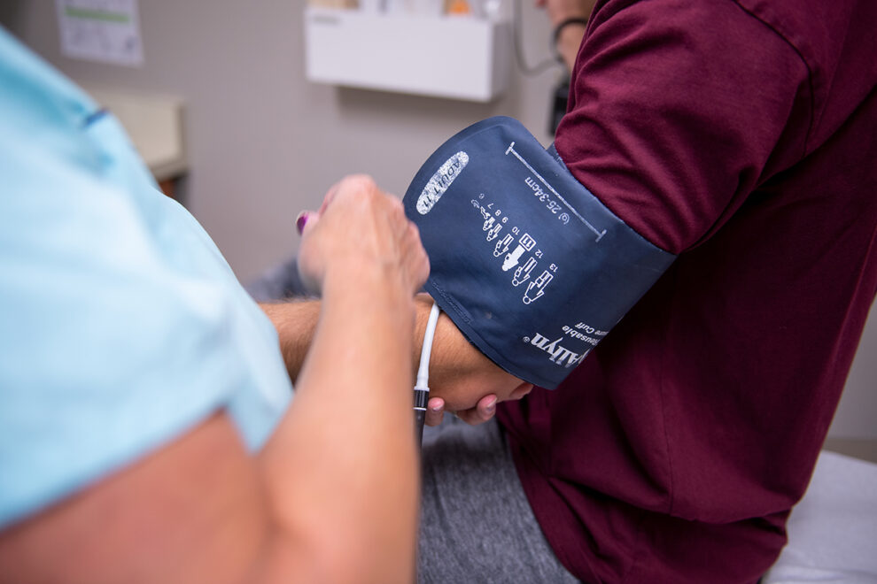 Closeup of someone administering a blood pressure test.