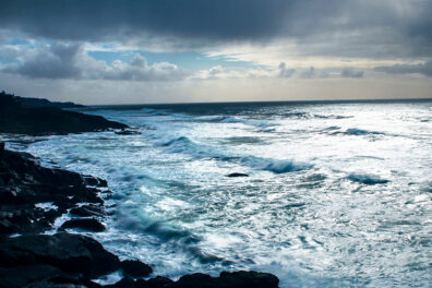 Ocean waves crashing against a rocky coastline.