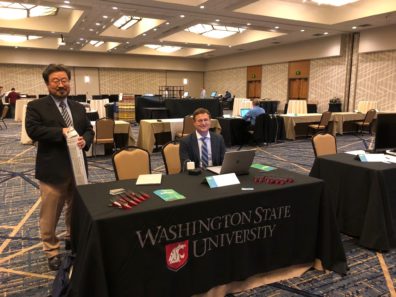 Chulhee Kang and James Brozik set up their booth for Photon Biosciences at SciTech NW 2018.