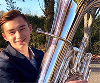 Timothy Schrader holding his tuba.