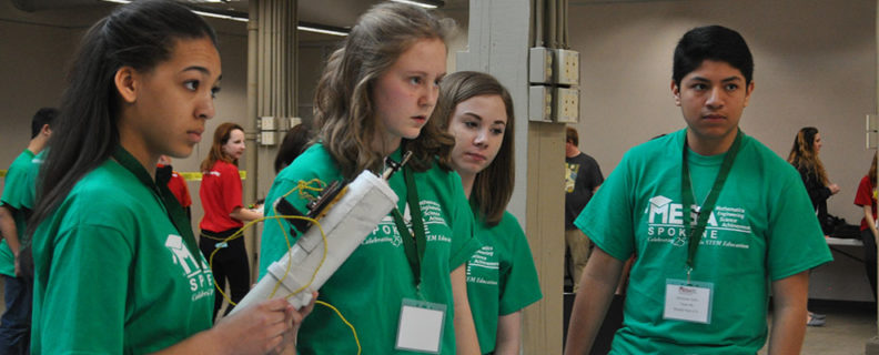 four students on green shirt team in mesa prosthetic arm training