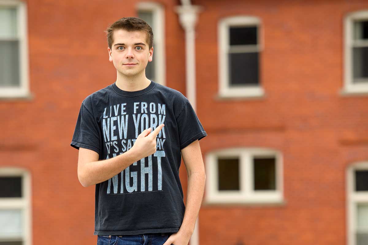 Jake pointing to Murrow Hall on WSU campus