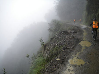 The "World's Most Dangerous Road," in Bolivia, offers spectacular views and landscapes as well as spectacular weather. Here a group rides down through a rain storm. Courtesy Derren Patterson