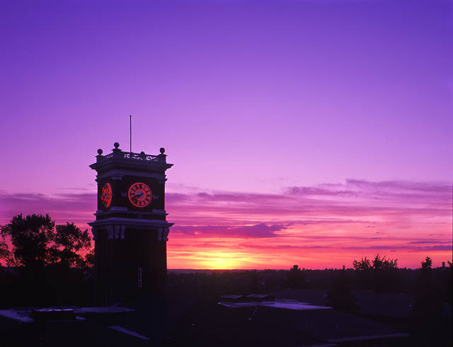 Bryan Hall clock tower with purple pink and yellow sunset